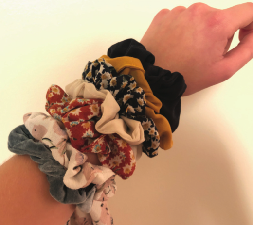 A personal collection of scrunchies with multiple patterns and textures.